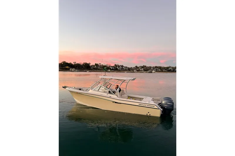Slide: The Image of 2012 Grady-White Freedom 275 boat on calm water at sunset. - 10