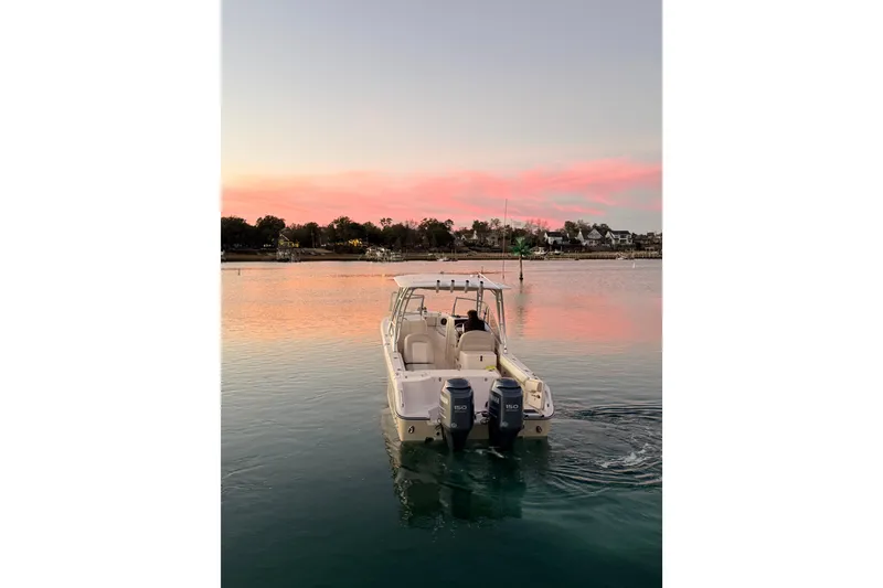 Slide: The Image of 2012 Grady-White Freedom 275 boat on serene water at sunset. - 13