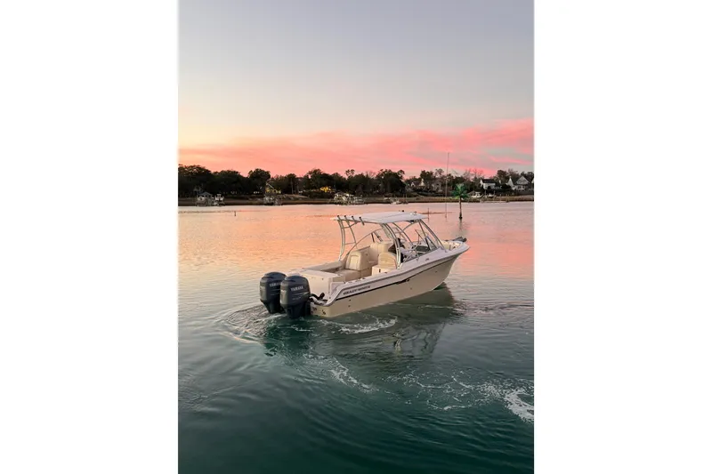 Slide: The Image of 2012 Grady-White Freedom 275 boat on serene water at sunset. - 16