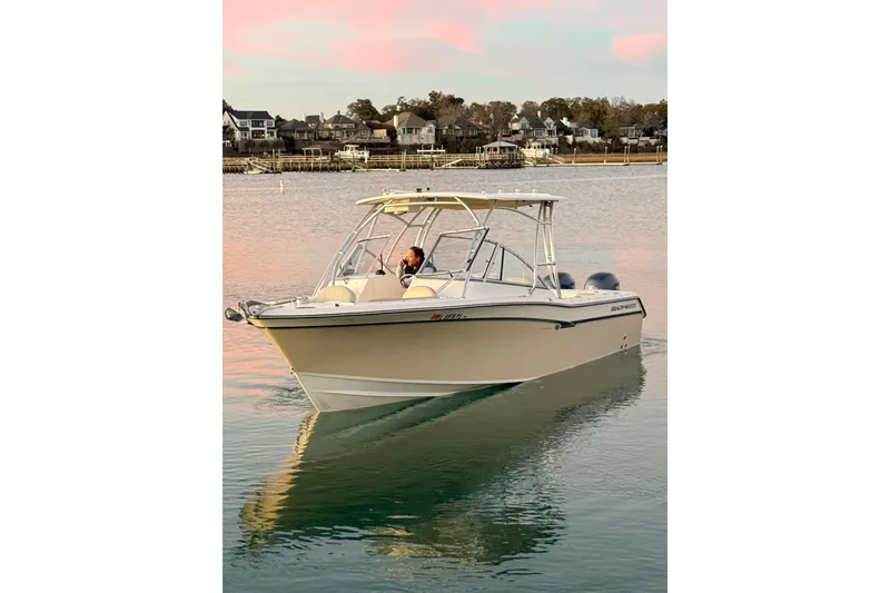 Slide: The Image of 2012 Grady-White Freedom 275 boat cruising on calm water at sunset. - 27
