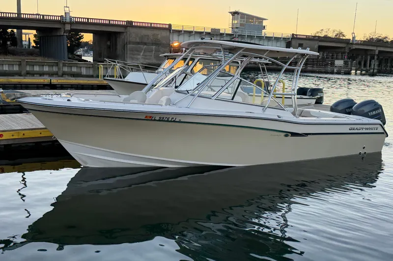 Slide: The Image of 2012 Grady-White Freedom 275 boat docked at sunset with Yamaha engines. - 28