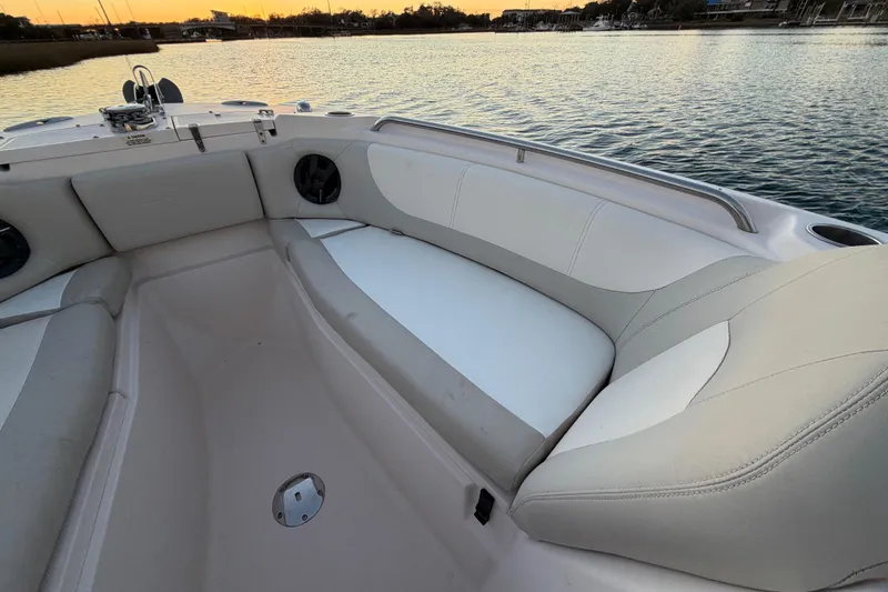 Slide: The Image of 2012 Grady-White Freedom 275 boat interior with cushioned seating at sunset. - 31