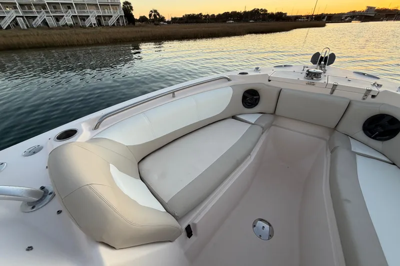 Slide: The Image of 2012 Grady-White Freedom 275 boat interior with cushioned seating at sunset. - 32