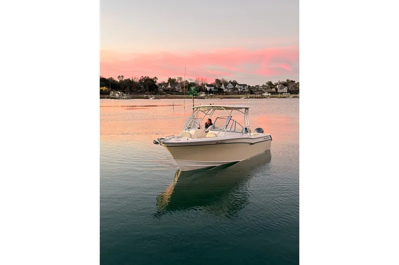 Slide: The Image of 2012 Grady-White Freedom 275 boat on serene water at sunset. - 4