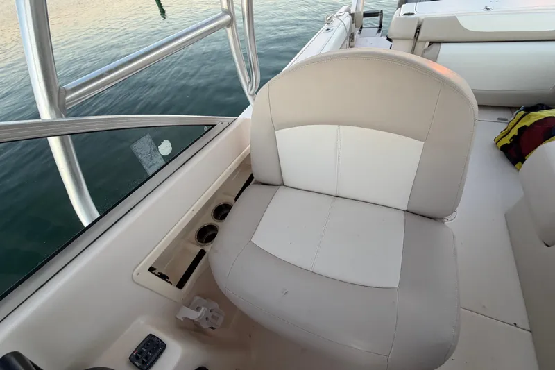 Slide: The Image of 2012 Grady-White Freedom 275 boat interior with cushioned seating and cup holders. - 40