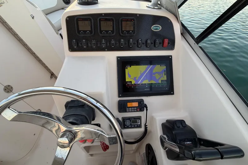 Slide: The Image of 2012 Grady-White Freedom 275 boat dashboard with navigation and control systems. - 44