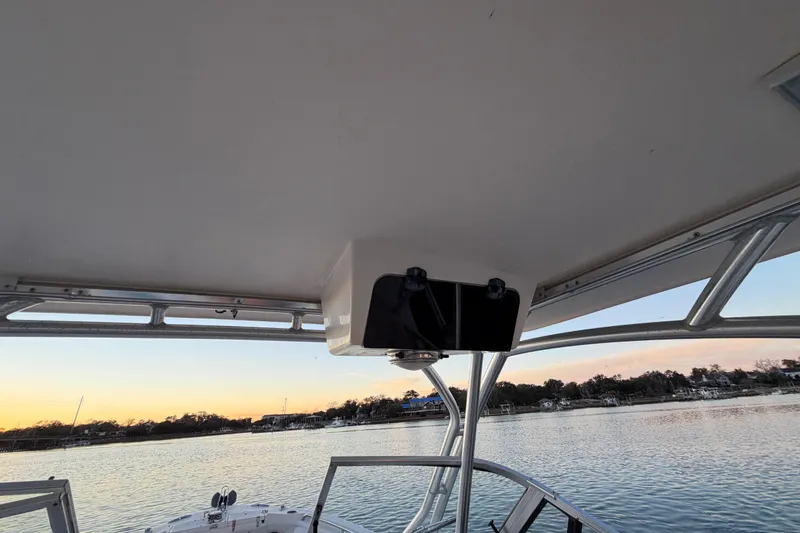 Slide: The Image of 2012 Grady-White Freedom 275 boat interior with scenic water view at sunset. - 47