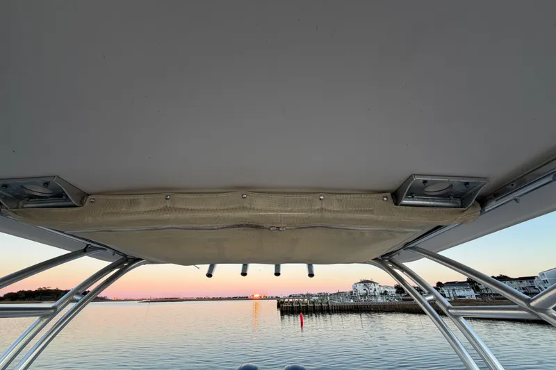 Slide: The Image of 2012 Grady-White Freedom 275 boat view at sunset on calm water. - 48
