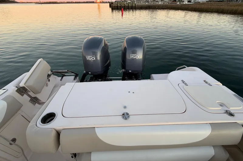 Slide: The Image of 2012 Grady-White Freedom 275 boat with twin Yamaha 150 engines on calm water. - 49