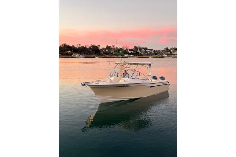 Slide: The Image of 2012 Grady-White Freedom 275 boat on serene water at sunset. - 5