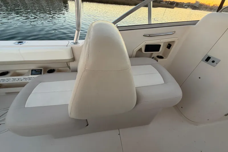 Slide: The Image of Grady-White Freedom 275 boat interior seating, 2012 model, near water at sunset. - 50