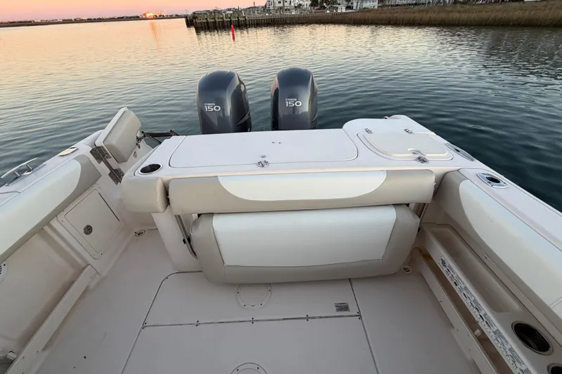 Slide: The Image of 2012 Grady-White Freedom 275 boat with twin Yamaha 150 engines on calm water. - 53