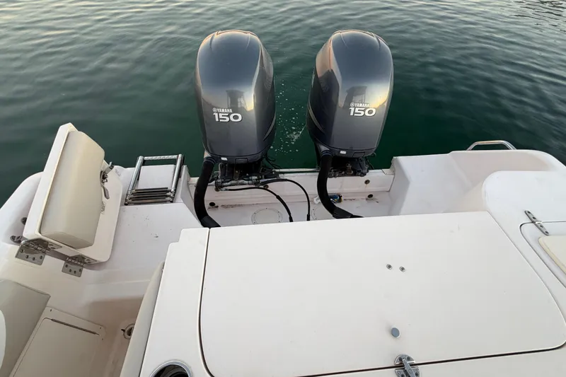 Slide: The Image of 2012 Grady-White Freedom 275 boat with twin Yamaha 150 engines on calm water. - 56