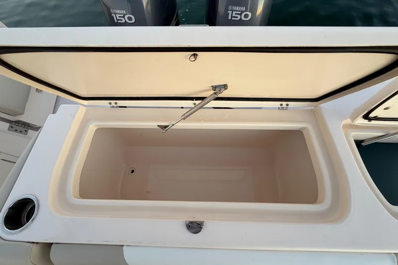 Slide: The Image of Open storage compartment on 2012 Grady-White Freedom 275 boat with Yamaha engines. - 57
