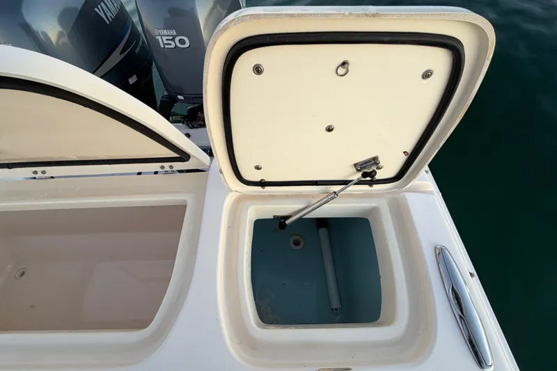 Slide: The Image of Open storage compartments on a 2012 Grady-White Freedom 275 boat with Yamaha 150 engines. - 58