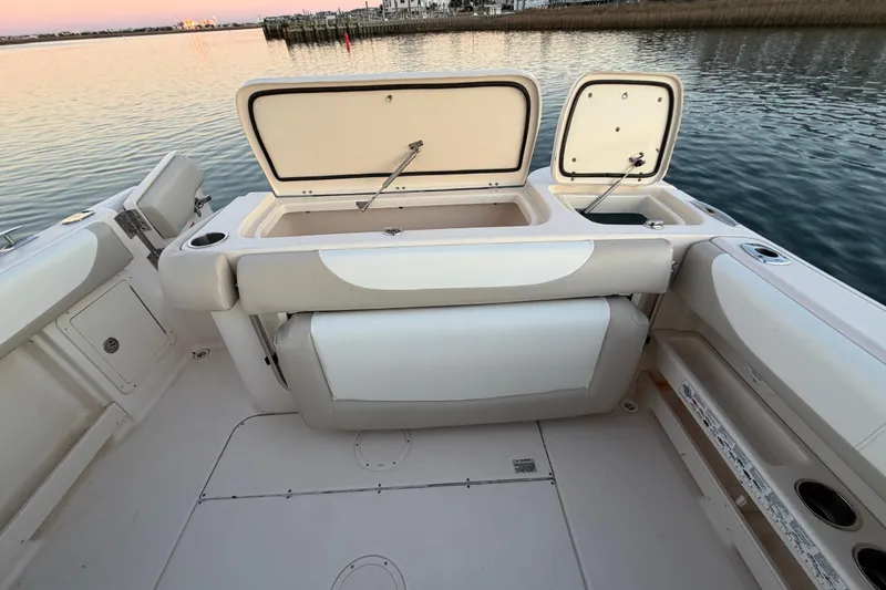 Slide: The Image of 2012 Grady-White Freedom 275 boat interior with open storage compartments by the water. - 59