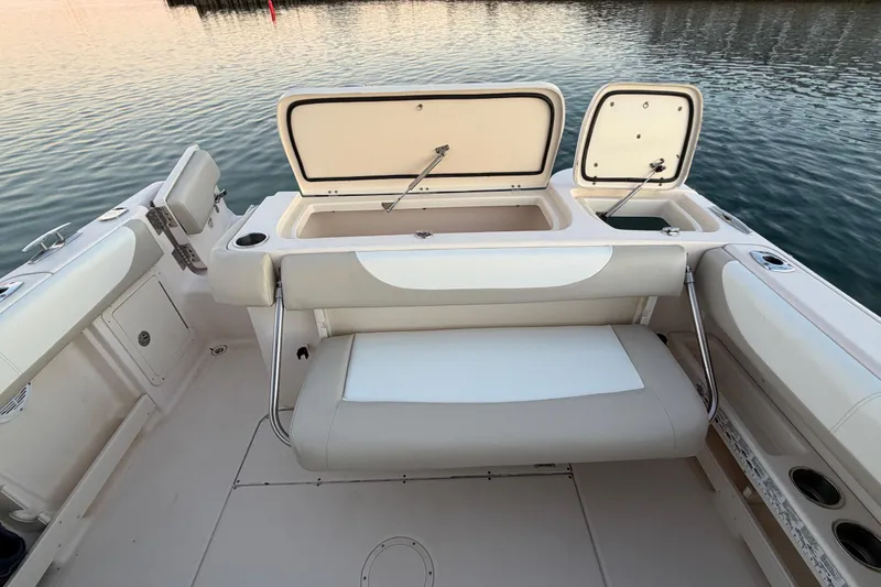 Slide: The Image of 2012 Grady-White Freedom 275 boat interior with open storage compartments and seating. - 60