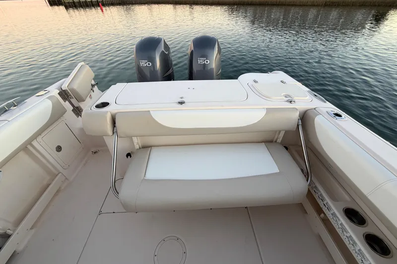 Slide: The Image of 2012 Grady-White Freedom 275 boat with dual Yamaha 150 engines, featuring a spacious seating area. - 62