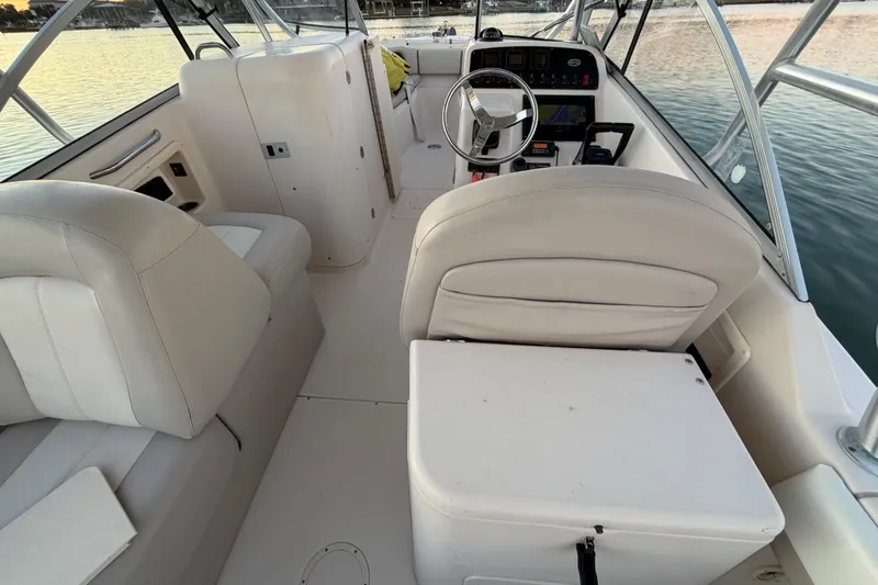 Slide: The Image of 2012 Grady-White Freedom 275 boat interior with steering wheel and seating. - 65