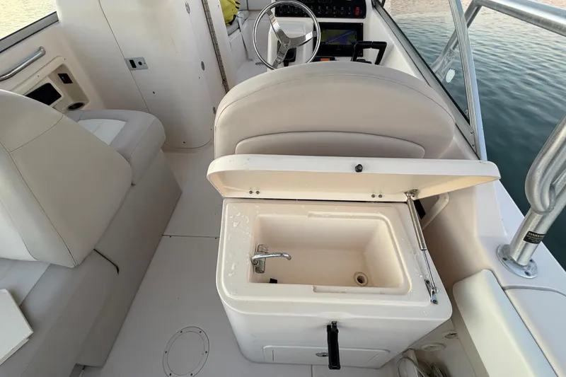 Slide: The Image of 2012 Grady-White Freedom 275 boat interior with open storage compartment. - 66
