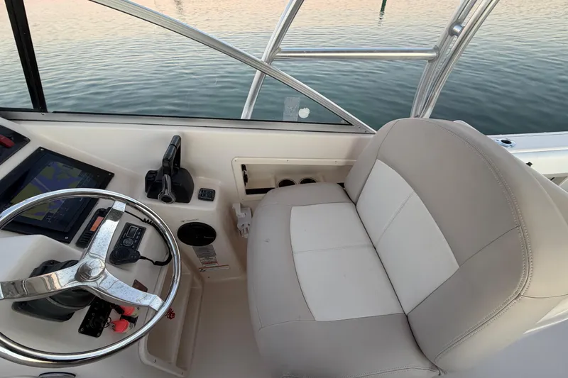 Slide: The Image of Interior view of 2012 Grady-White Freedom 275 boat cockpit with steering wheel and seat. - 67