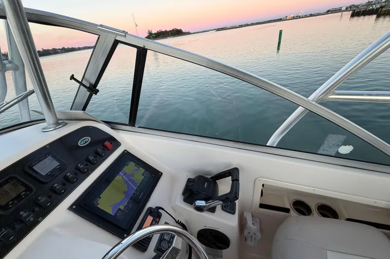 Slide: The Image of 2012 Grady-White Freedom 275 boat dashboard with navigation system at sunset. - 69
