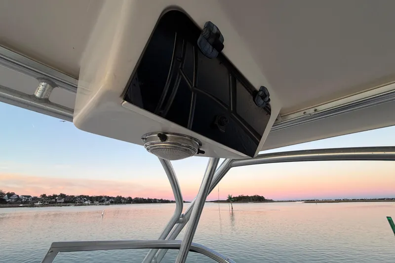 Slide: The Image of 2012 Grady-White Freedom 275 boat interior with sunset view over calm water. - 70