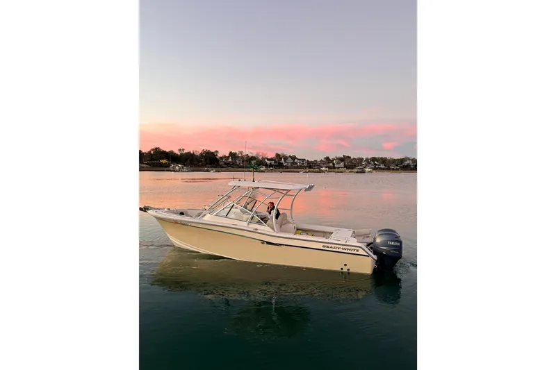 Slide: The Image of 2012 Grady-White Freedom 275 boat on calm water at sunset. - 8