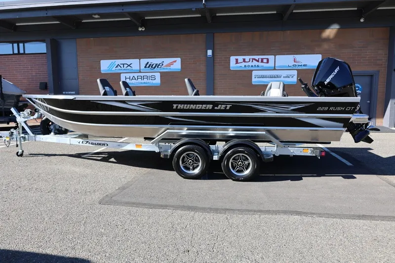 The Image of 2026 Thunder Jet 229 Rush OT boat on trailer, parked outside dealership. - 17