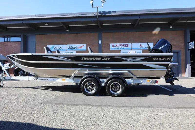 Slide: The Image of 2026 Thunder Jet 229 Rush OT boat on trailer, displayed outdoors. - 20