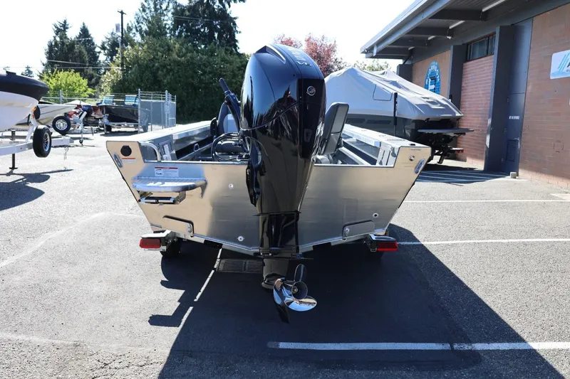 Slide: The Image of 2026 Thunder Jet 229 Rush OT boat with outboard motor in a parking lot. - 23