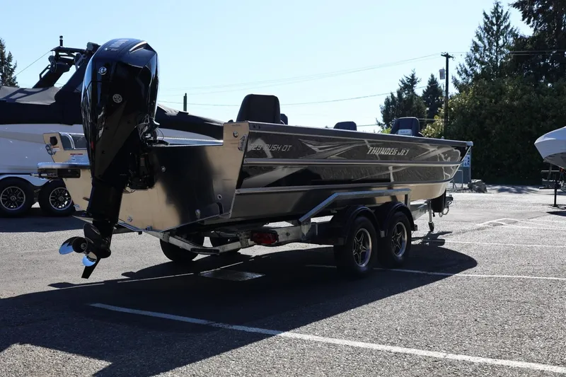 Slide: The Image of 2026 Thunder Jet 229 Rush OT boat on trailer in parking lot, rear view. - 29