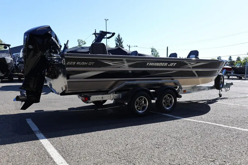 Slide: The Image of 2026 Thunder Jet 229 Rush OT boat on trailer in parking lot, side view. - 31