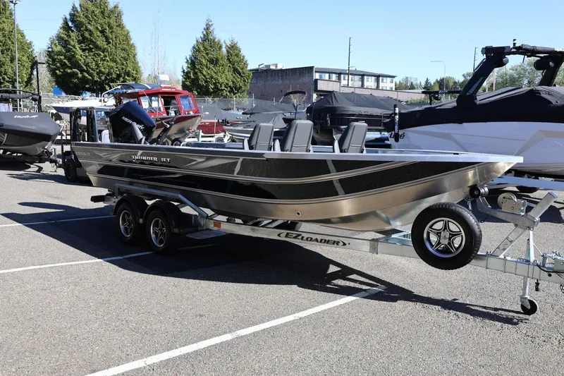 Slide: The Image of 2026 Thunder Jet 229 Rush OT boat on trailer in parking lot. - 32