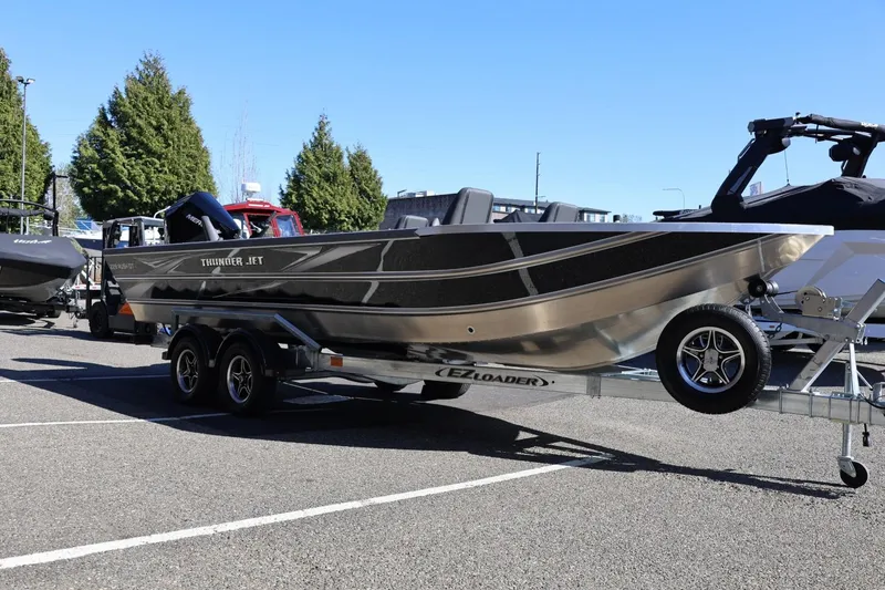 Slide: The Image of 2026 Thunder Jet 229 Rush OT boat on trailer, parked outdoors. - 33