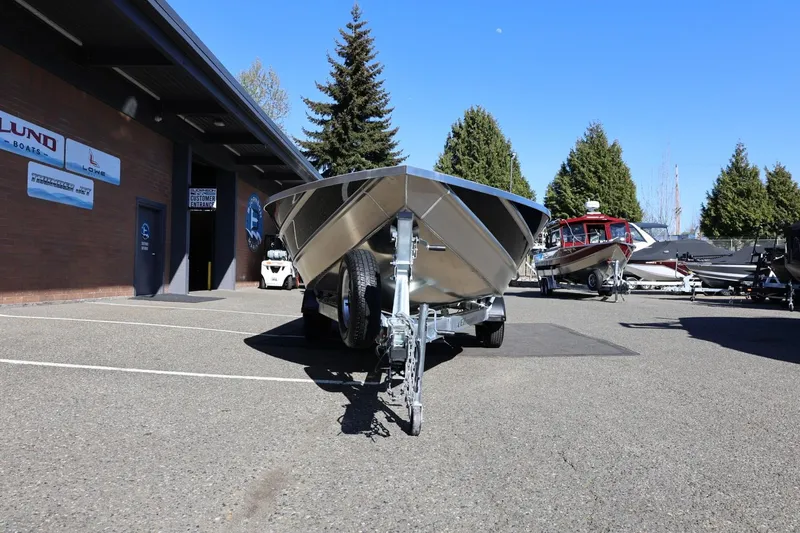 Slide: The Image of 2026 Thunder Jet 229 Rush OT boat on trailer in dealership parking lot. - 35
