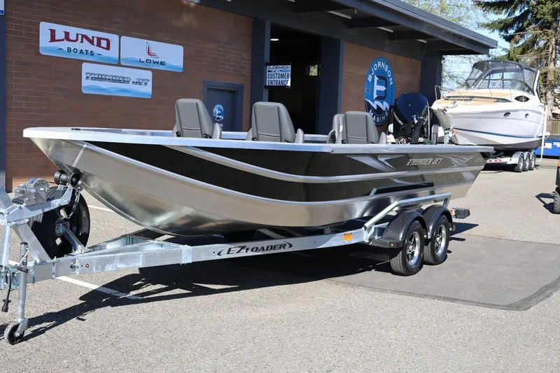 Slide: The Image of 2026 Thunder Jet 229 Rush OT boat on trailer outside marine dealership. - 36