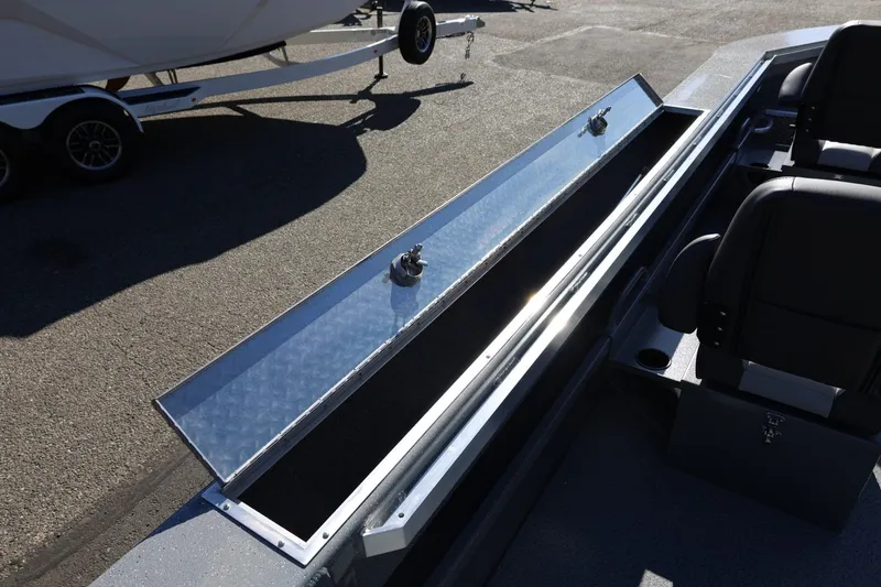 Slide: The Image of Open storage compartment on 2026 Thunder Jet 229 Rush OT boat, with seating visible. - 48
