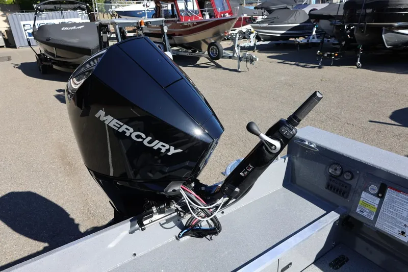 Slide: The Image of 2026 Thunder Jet 229 Rush OT with Mercury outboard motor in a boatyard. - 52