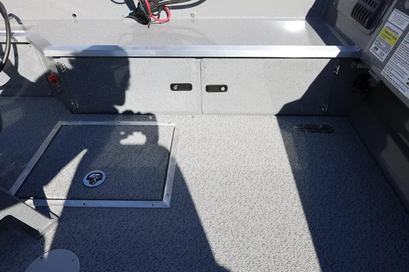 Slide: The Image of Interior of 2026 Thunder Jet 229 Rush OT boat, featuring storage compartments and textured flooring. - 53