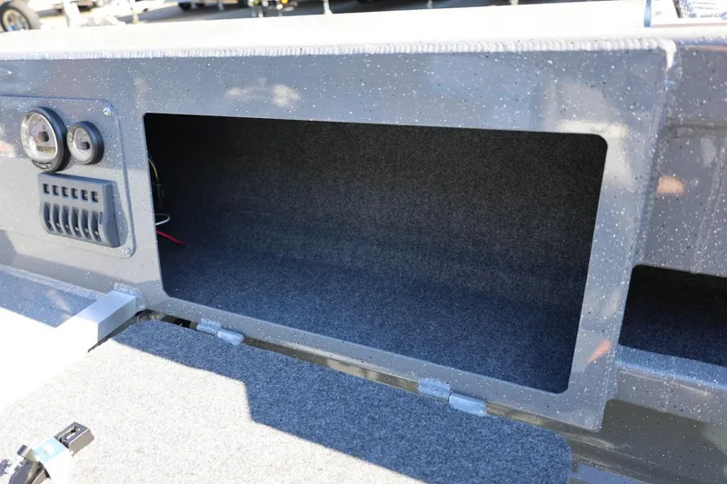 Slide: The Image of Interior storage compartment of 2026 Thunder Jet 229 Rush OT boat, featuring control panel. - 56