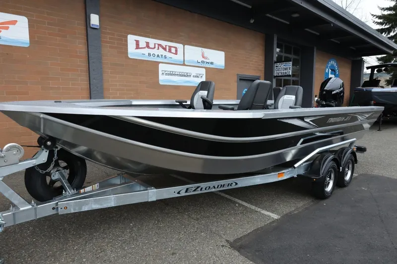 Slide: The Image of 2026 Thunder Jet 229 Rush OT boat on trailer outside dealership. - 8