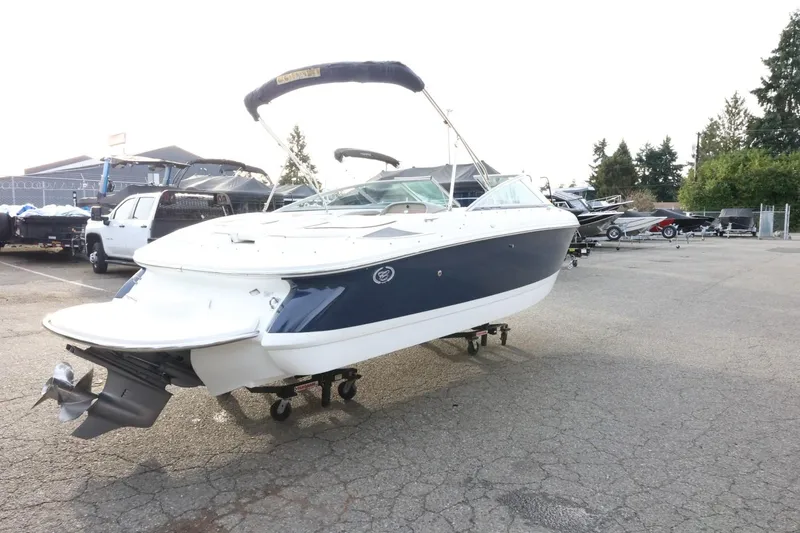 Slide: The Image of 2005 Cobalt 200 boat on trailer in parking lot, surrounded by other vehicles. - 10