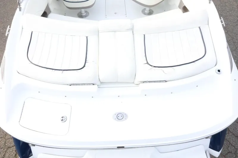 Slide: The Image of 2005 Cobalt 200 boat with white cushioned seating and storage compartment. - 12