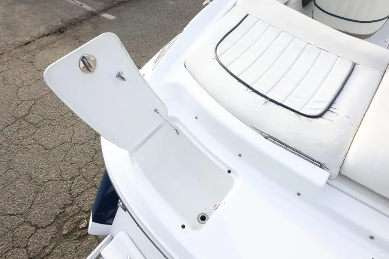 Slide: The Image of Open storage compartment on 2005 Cobalt 200 boat with white seating. - 13
