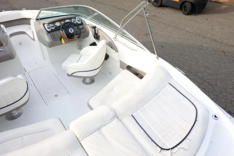 Slide: The Image of 2005 Cobalt 200 boat interior with white seating and control panel. - 15