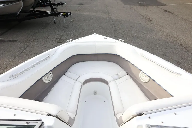 Slide: The Image of Bow seating area of a 2005 Cobalt 200 boat with white upholstery. - 17