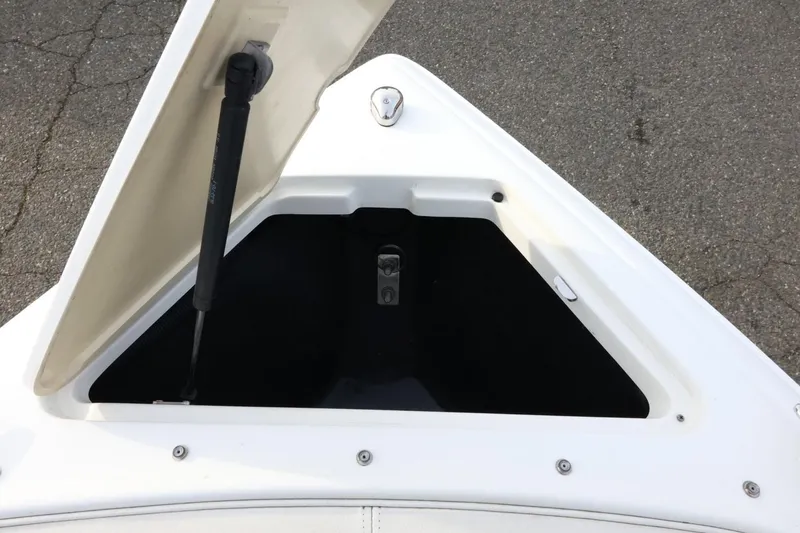 Slide: The Image of Open storage compartment on a 2005 Cobalt 200 boat, showing interior details. - 21