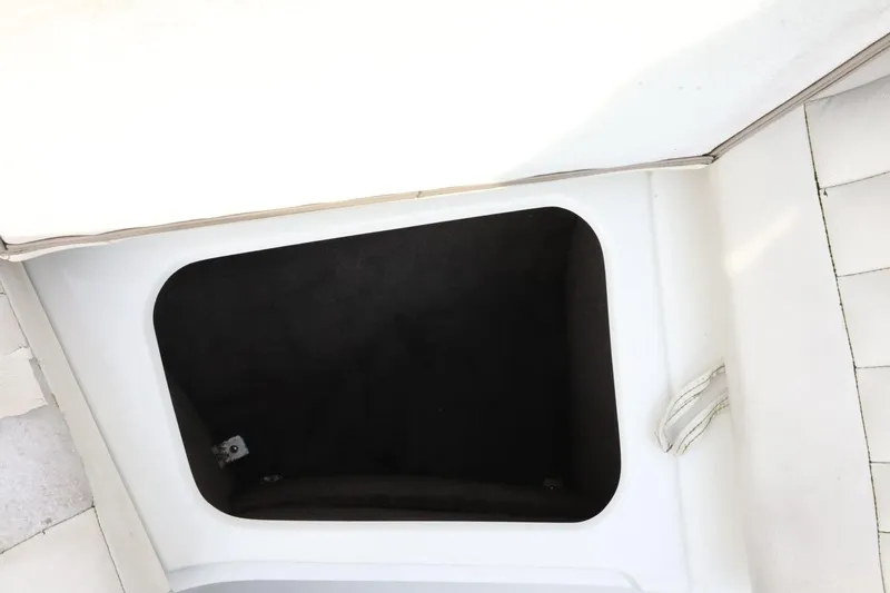 Slide: The Image of Open storage compartment in a 2005 Cobalt 200 boat interior. - 23