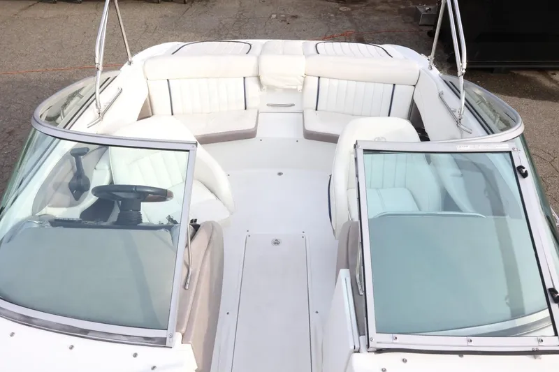Slide: The Image of 2005 Cobalt 200 boat interior with white seating and dual windshields. - 27